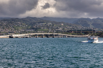Oahu, Hawaii, USA. - January 10, 2012: Pearl Harbor. Ford Island bridge froms white line between...