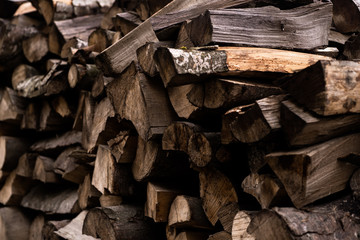 Wooden background. Firewood stack for the background. A lot of cutted logs. Stack of sawn logs. Natural wooden decor background. Pile of chopped fire wood prepared for winter.