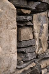 pattern gray color of modern style design decorative uneven cracked real stone wall surface with cement.Stone wall for background. Stone wall texture. Part of a stone wall, for background or texture