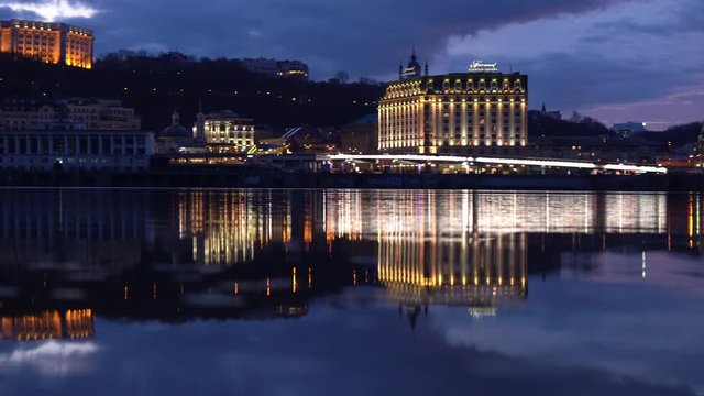 Panoramic night view of Kyiv reflecting in the waters of Dnipro river, Ukraine
