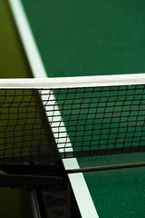 Table Tennis or ping pong rackets and balls on table. Sport concept.Texture of green wooden table,equipment for table tennis sport