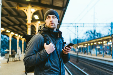 Sopot Railway station. traveler waiting for transportation. Travel concept. Man at the train station. Portrait Caucasian Male In Railway Train Station. Handsome commuter while waiting for his train