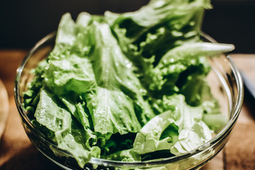 Green and juicy salad in a transparent bowl.