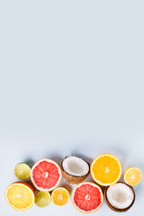 Summer holidays, resort vacation, exotic fruits background. Summertime vibes. Composition with citrus slices on white surface, copy space