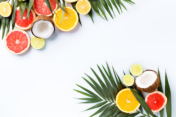 Summer holidays, resort vacation, exotic fruits background. Summertime vibes. Composition with citrus slices on white surface, copy space