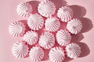 Pink marshmallows on a pink background, top view