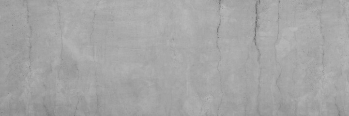 Texture of a smooth gray concrete wall with cracks as a background or wallpaper