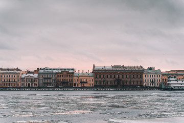 Saint Petersburg. the Neva river in the ice. view of the embankment in winter. old houses in the distance