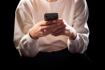 Young man in a sports suit with a smartphone