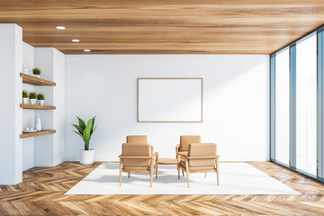 White office lounge with armchairs and poster