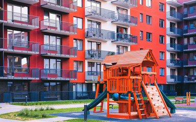 Fototapeta na wymiar Children playground at Modern residential apartment house complex outdoor facility