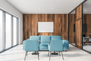 Office lounge with blue sofas and poster