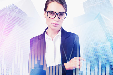 Confident businesswoman in city, financial graph