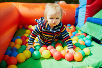 Little girl playing in ball pool