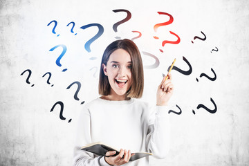 Fototapeta premium Happy teen girl with notebook, question marks