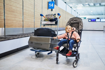 Adorable little toddler girl in international airport