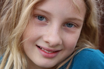 Closeup of a smiling beautiful innocent blonde teenage girl