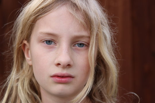 Portrait of a young teenage girl with a serious stare