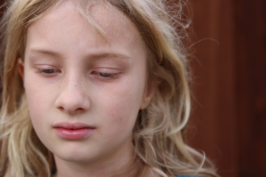 Portrait Of A Beautiful Blonde Girl With Her Eyes Averted