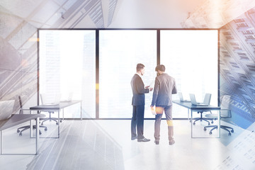 Obraz premium Two businessmen in spacious open space office