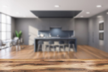 Table in blurry gray kitchen with bar