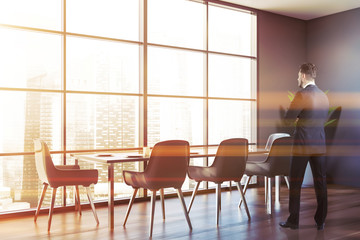 Man in gray dining room with laid table