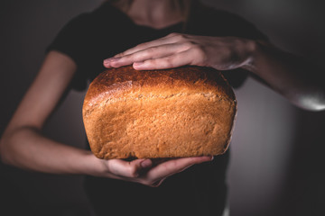 the cook is holding rye bread. national Russian black bread