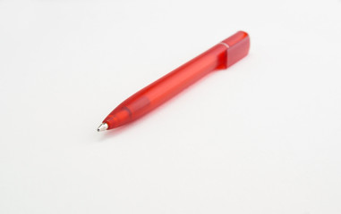 plastic red ballpoint pen on white background