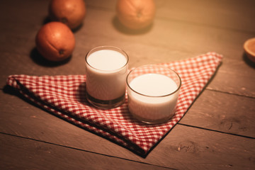 Milk, banana and oranges on a table