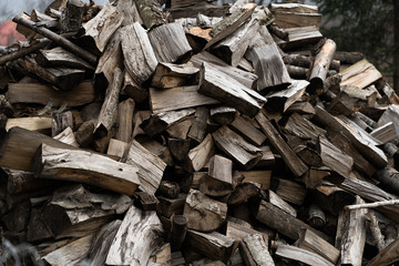 Wooden background. Firewood stack for the background. A lot of cutted logs. Stack of sawn logs. Natural wooden decor background. Pile of chopped fire wood prepared for winter.