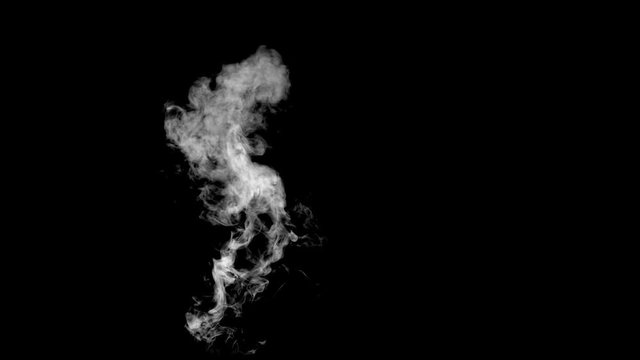 White steam spins and rises from the pan. White smoke rises from a large pot, which is located behind the frame. Isolated seamless loop black background.