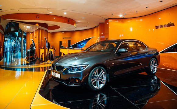 HAMBURG, GERMANY - MAR 20, 2018: Luxury BMW coupe limousine presented at the SIXT rent-a-car stand in Hamburg international Airport with orange colored walls