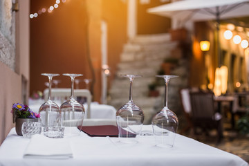 Table setting with empty glasses, plates and cutlery indoors