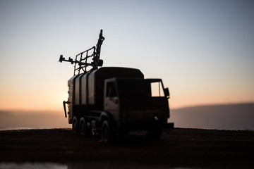 Satellite dishes or radio antennas against evening sky. Selective focus
