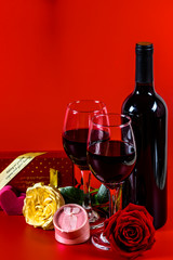 Roses, red wine, gift box and heart