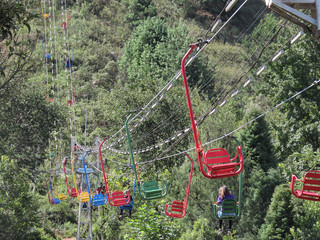 Several chairlift chairs in various colors