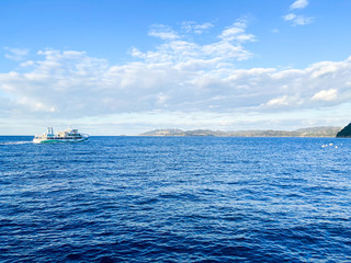 Fototapeta na wymiar Japan blue sky and sea and tourist boat.