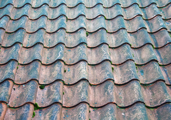 a full frame image of traditional old terracotta curved overlapping pantile roof tiles