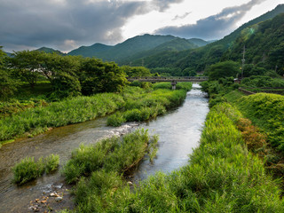 Fototapeta na wymiar stream flow in a woods in countryside of Yamaguchi prefecture, JAPAN.