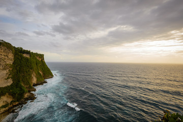 A view of Idian Ocean from Bali, Indonesia. Beautiful blue ocean water and a hanging cliff by the sea