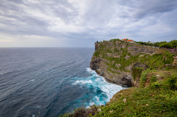 Fototapeta na wymiar A view of Idian Ocean from Bali, Indonesia. Beautiful blue ocean water and a hanging cliff by the sea