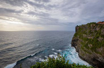 Fototapeta na wymiar A view of Idian Ocean from Bali, Indonesia. Beautiful blue ocean water and a hanging cliff by the sea