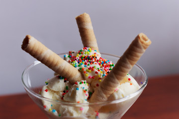 Vanilla and strawberry ice cream served in glasses, with sweet sprinkles and, Bogotá Colombia,...