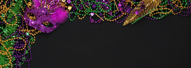 Purple, Gold, and Green Mardi Gras beads and masks background