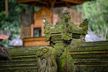 Balinese sculptures and architectural details in a temple, antique and rich of local culture