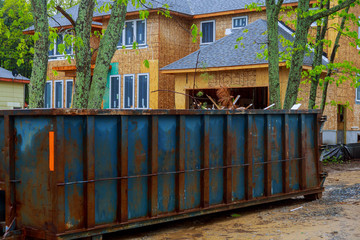 Fototapeta na wymiar Construction trash dumpsters in an metal container, home house renovation.