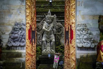 Balinese sculptures and traditional architectural details in a temple near Ubud, Bali, Indonesia