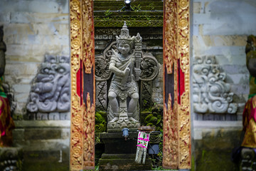 Balinese sculptures and traditional architectural details in a temple near Ubud, Bali, Indonesia