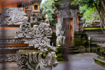 Fototapeta na wymiar Balinese sculptures and traditional architectural details in a temple near Ubud, Bali, Indonesia
