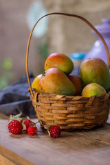 Basket with mango tropical fruit and artificial raspberry